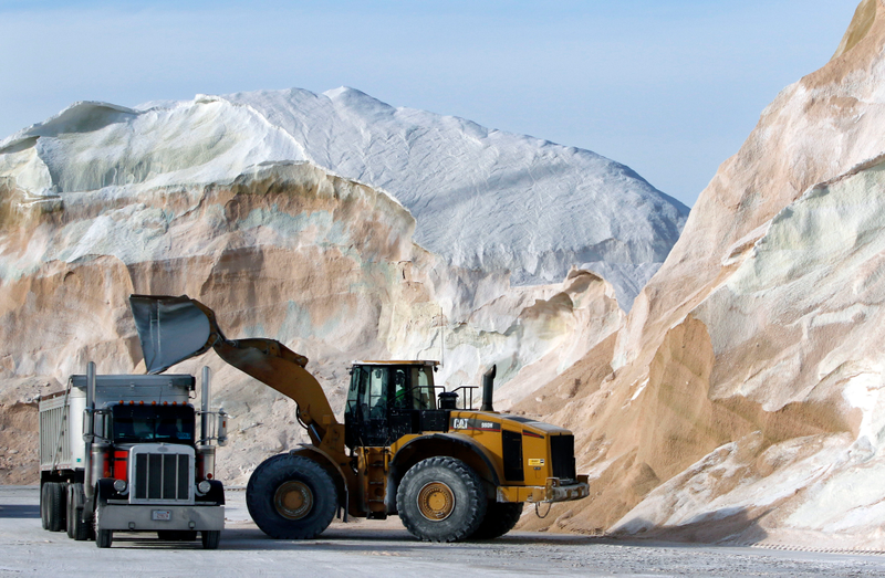 Road salt is loaded into a truck surrounded by mountains of salt at Eastern Minerals Inc., Wednesday, Jan. 3, 2018, in the Boston suburb of Chelsea, Mass. Photo credit: AP Photo/Bill Sikes